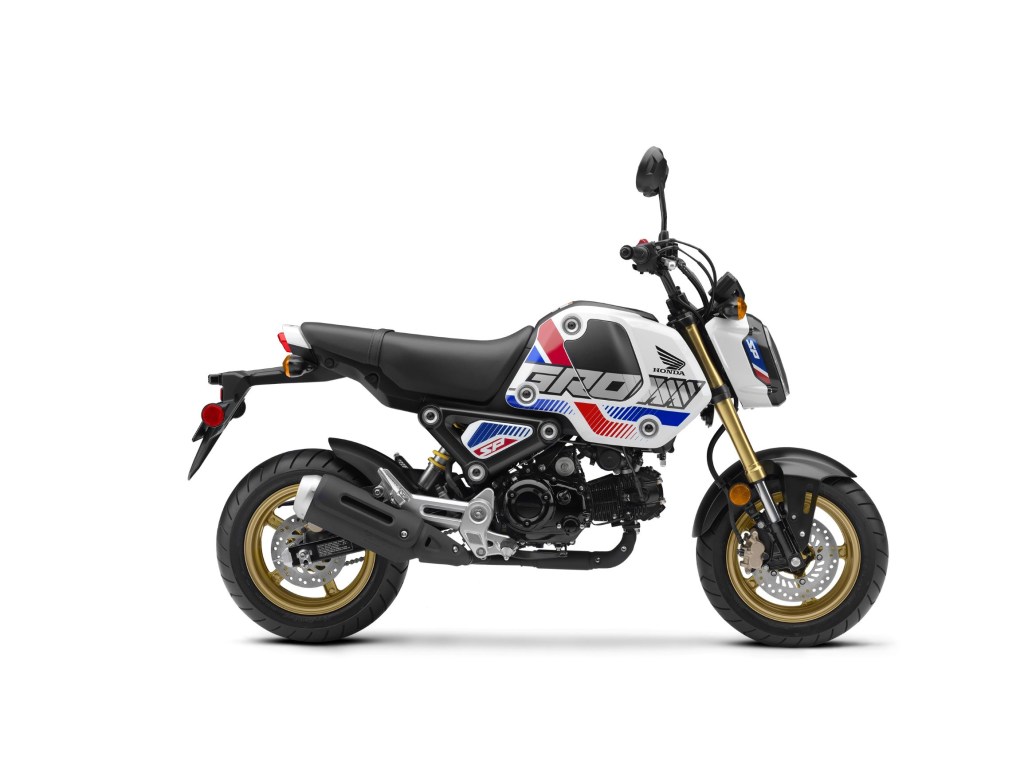 The side view of a 2022 Honda Grom in white-red-and-blue RHP livery with gold elements