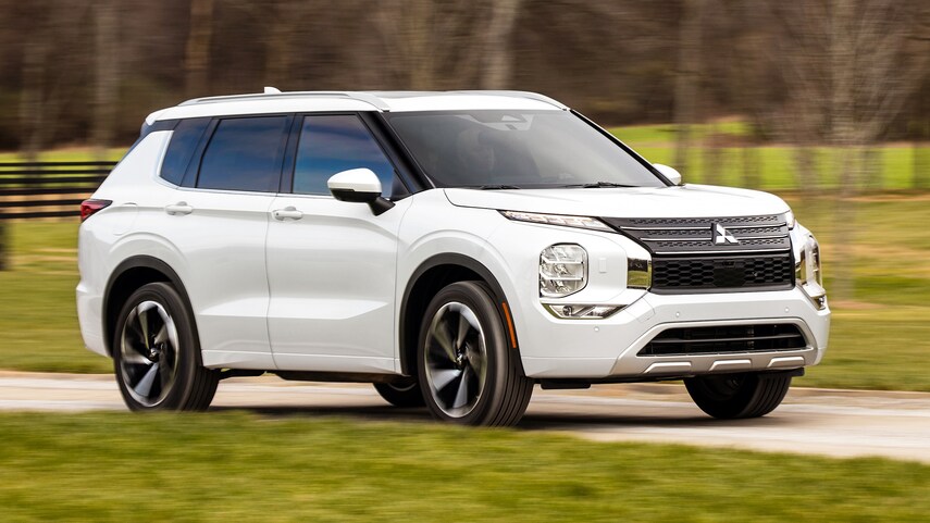 A white 2022 Mitsubishi Outlander driving through the country
