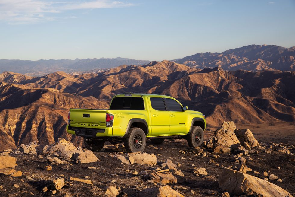 The 2022 Toyota Tacoma TRD Pro in Electric Lime parked on rocks 