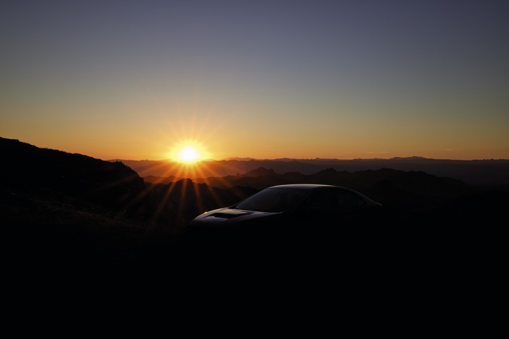 The new 2022 Subaru WRX silhouetted by the sunset