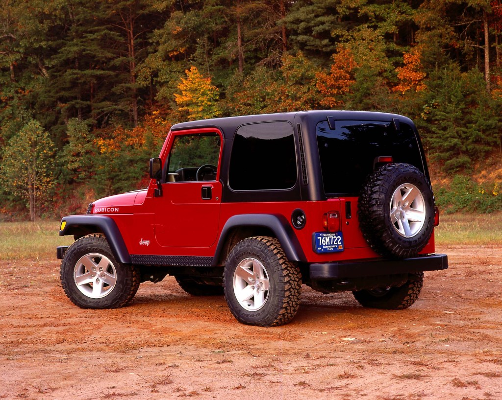 The rear of a red TJ Wrangler photographed at sunset