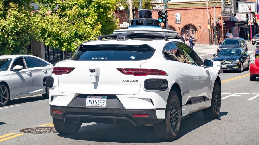 A white Waymo semi-autonomous Jaguar I-Pace car testing on the streets of San Francisco