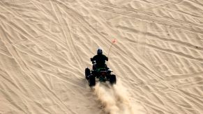 An ATV travels on a sand dune in a designated off-road vehicle area in the Oregon Dunes National Recreation Area
