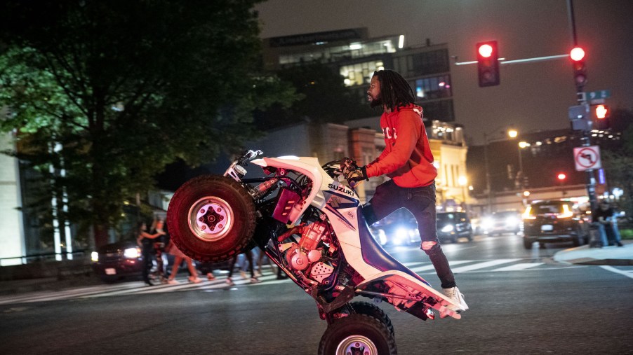 A man rides an ATV on U Street in Washington, D.C., the night of June 11, 2021