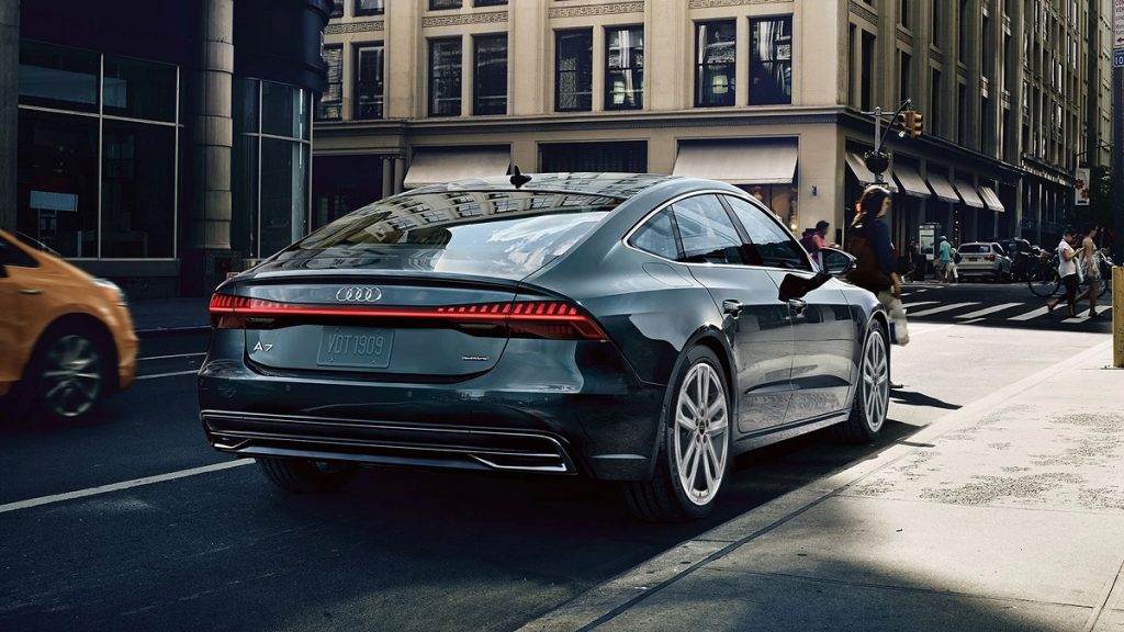 A dark green Audi A7 parked along a curb.