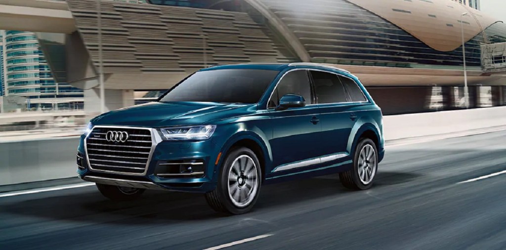 A blue 2021 Audi Q7 drives down the highway.