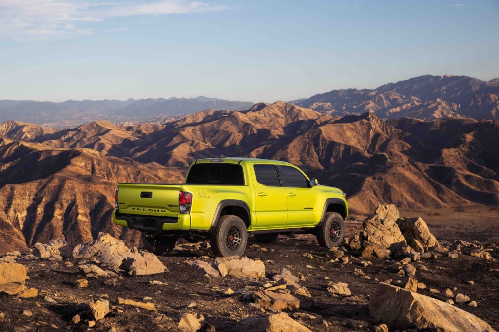 the electric green Toyota Tacoma TRD Pro color for 2022 perched on top of a Rocky Mountain