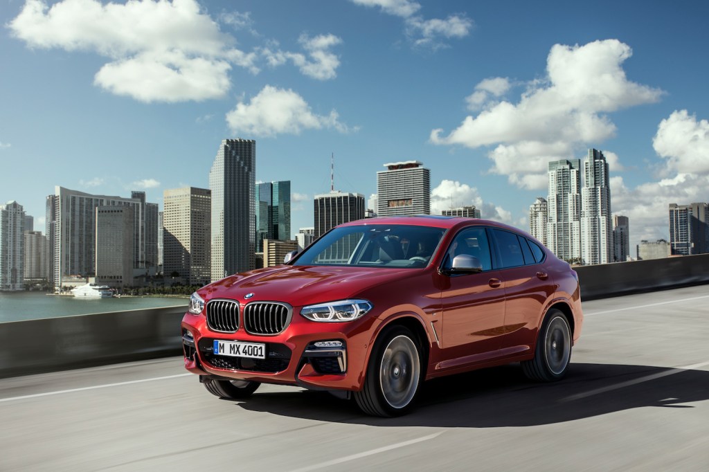 A red BMW X4 driving, the X4 is one of the fastest new SUVs under $50,000