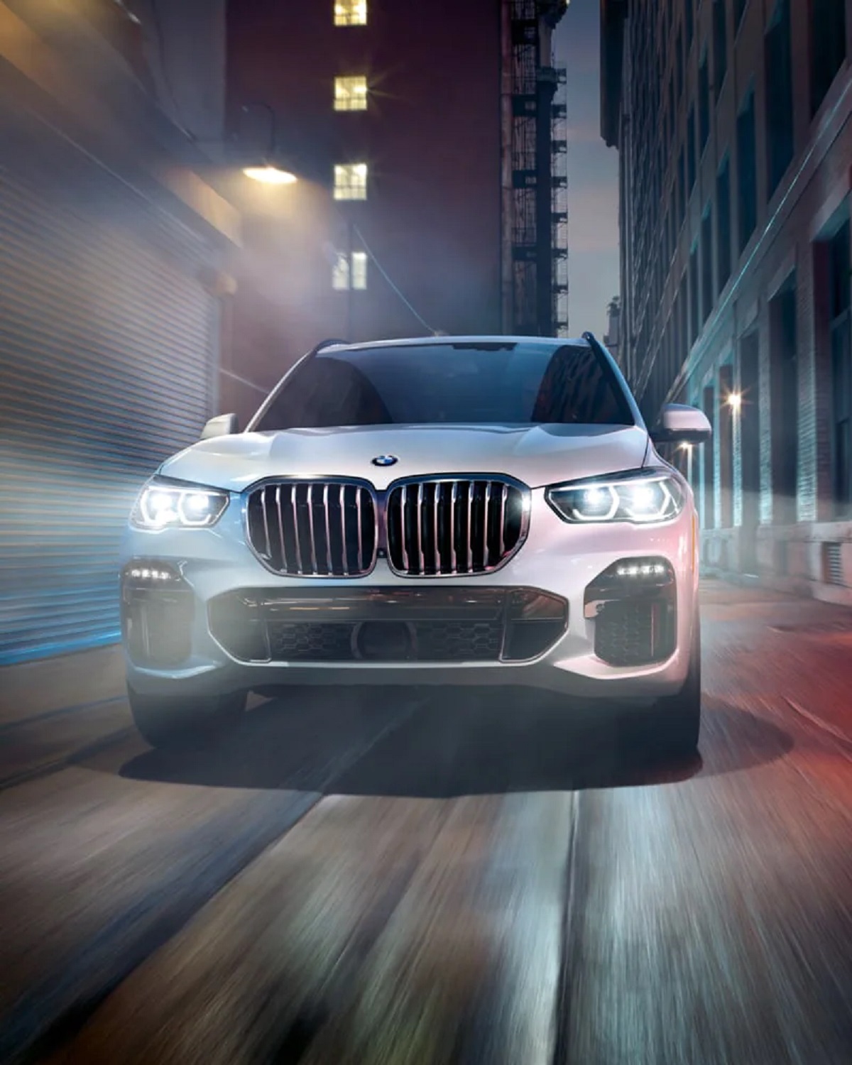 A 2021 BMW X5 drives at night.