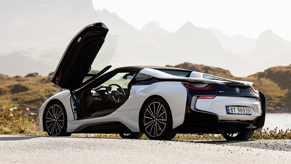 A white BMW i8 with its door opened.