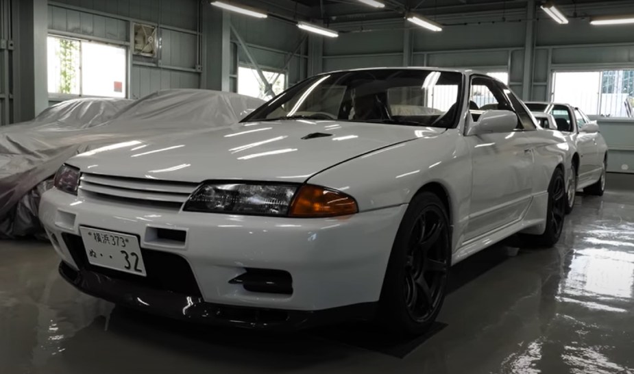 A white Built by Legends Nissan R32 Skyline GT-R restomod in the BBL surrounded by other cars