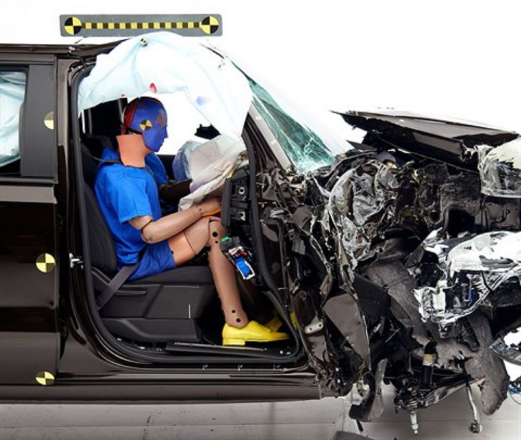 A dummy sitting in the passenger seat of a Chevy Silverado 1500.