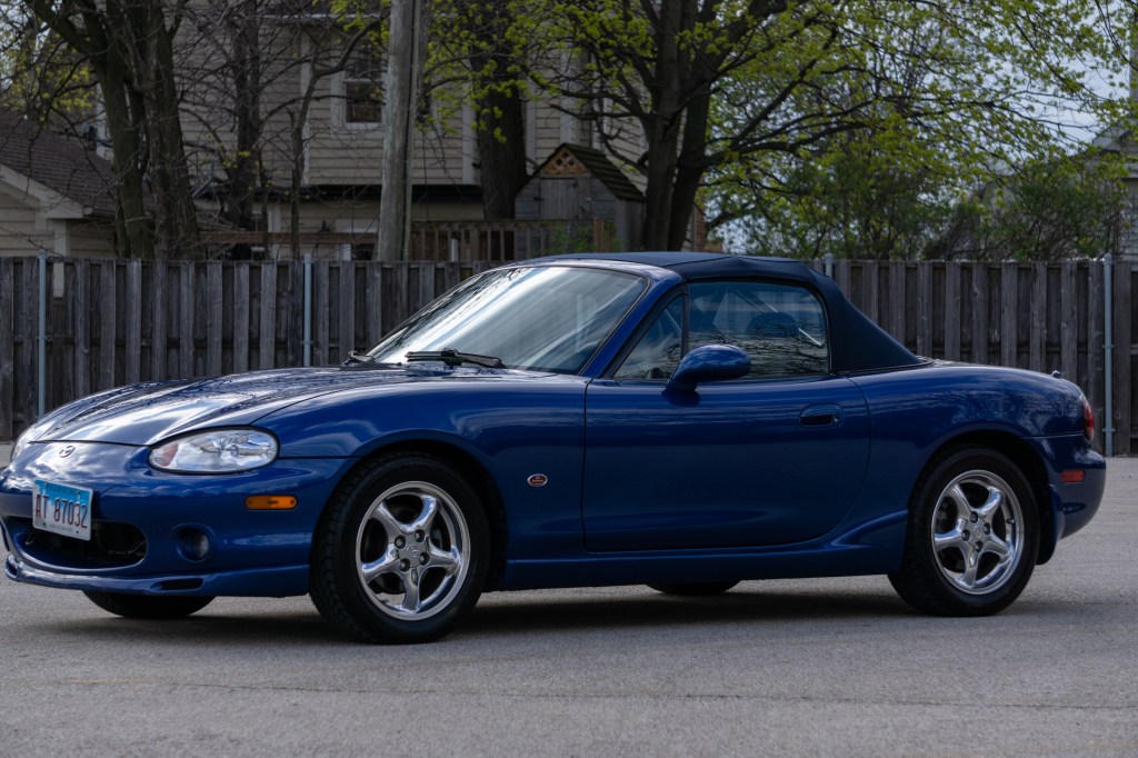 A blue 1999 Mazda MX-5 Miata 10th Anniversary Edition in a parking lot