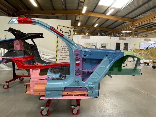 An image of the frame out of a Toyota Supra in a workshop.