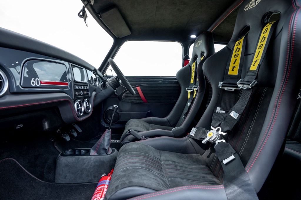 A side view of the Sabelt front seats and gray dashboard of a David Brown Automotive Mini Remastered Oselli Edition