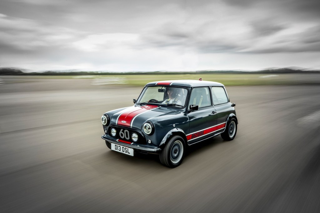 A gray-and-red David Brown Automotive Mini Remastered Oselli Edition goes around a track