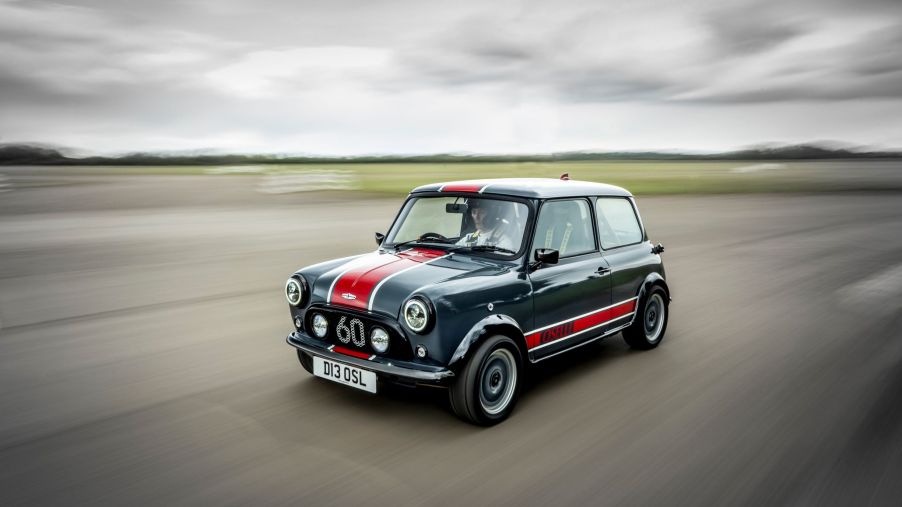 A gray-and-red David Brown Automotive Mini Remastered Oselli Edition goes around a track