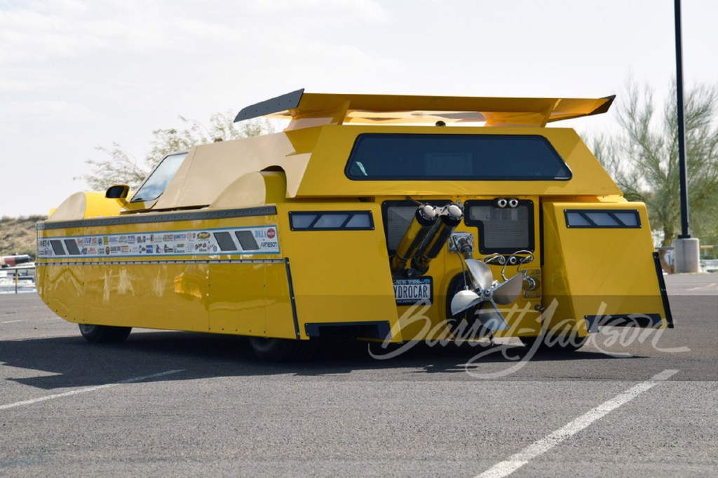 The rear 3/4 view of the yellow Dobbertin Hydrocar in a parking lot