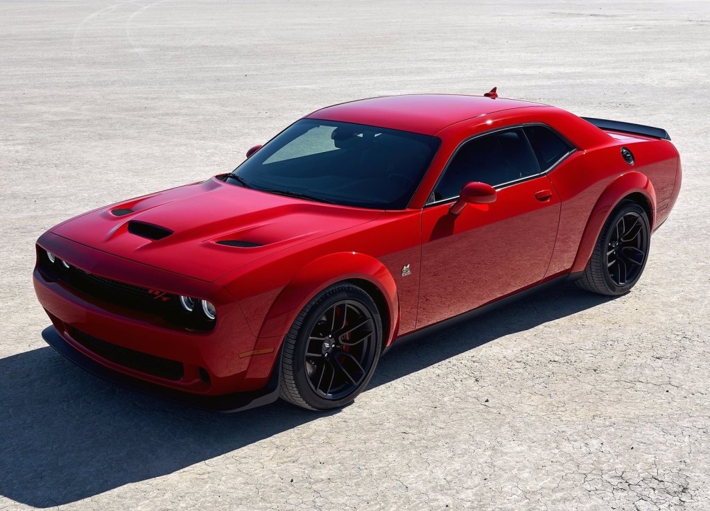 A red Dodge Challenger Hellcat parked outdoors.