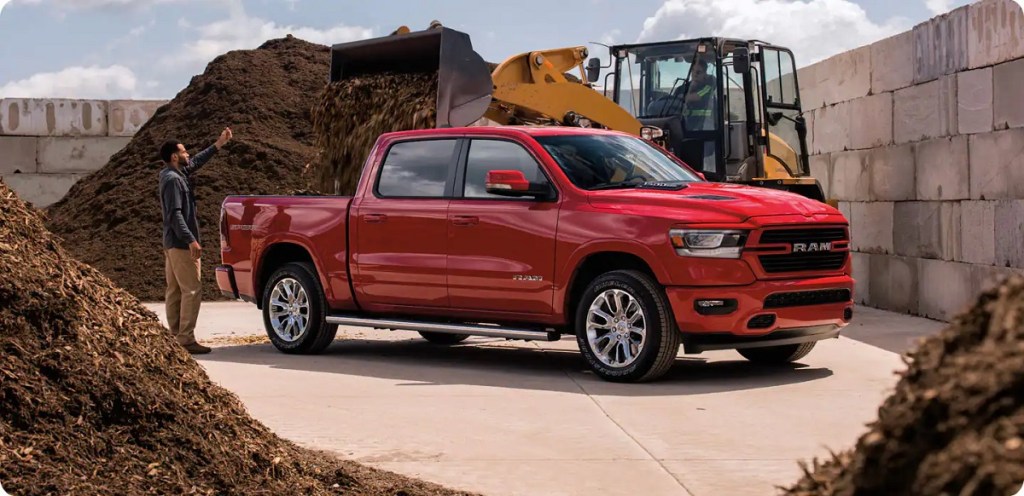 A red 2021 Dodge Ram 1500 surrounded by dirt piles.