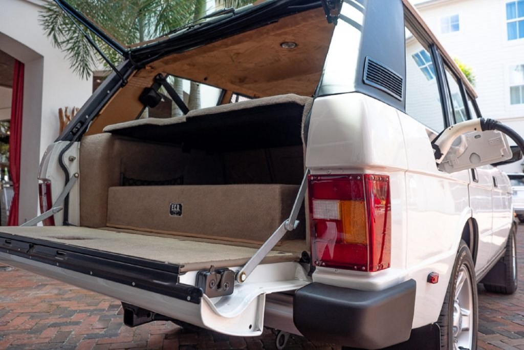 The rear view and cargo area of the white ECD electric Range Rover Classic