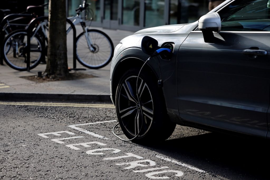 A charging cable is pictured plugged into a Volvo electric vehicle (EV), parked in a parking bay reserved for electric vehicles, in London. Good charging habits can help EV owners overcome EV range anxiety.