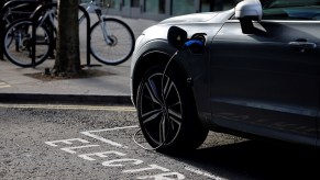A charging cable is pictured plugged into a Volvo electric vehicle (EV), parked in a parking bay reserved for electric vehicles, in London. Good charging habits can help EV owners overcome EV range anxiety.