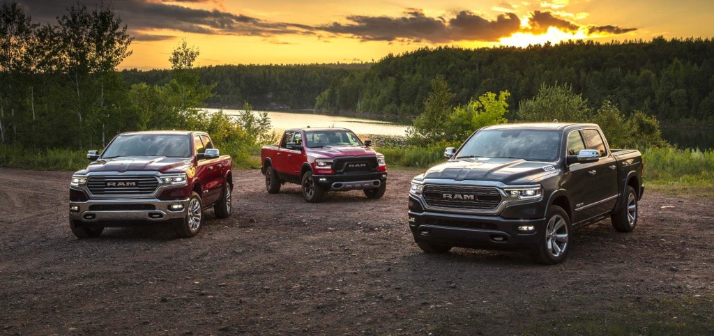 three ecodiesel 2021 ram 1500 models in gravel near a wooded lakeshore.