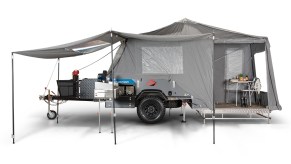 the cub explorer camper trailer set up for a press photo with the tent erected against a white backdrop