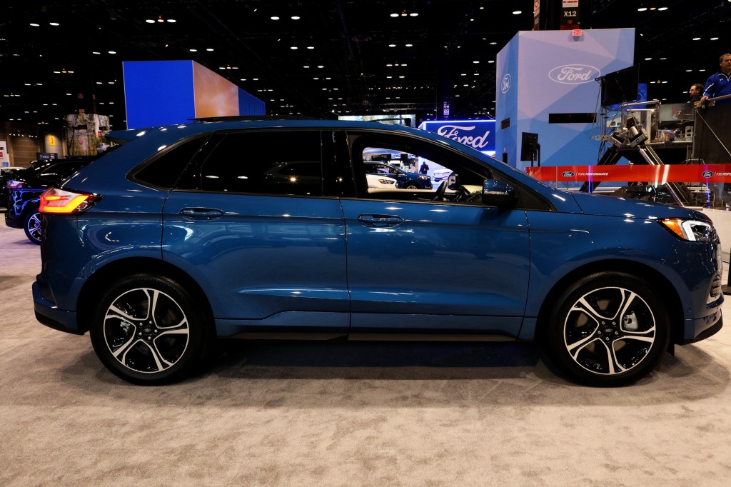 A blue Ford Edge crossover on display