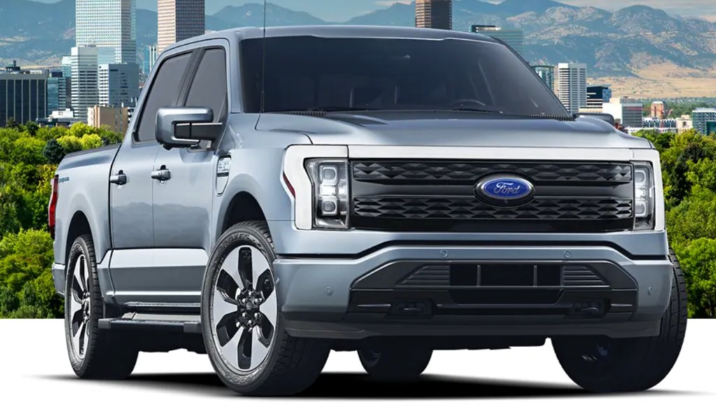 The 2022 Ford F-150 Lightning parked in front of buildings 