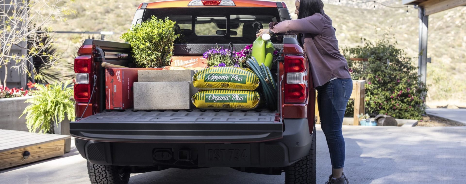 loading the Ford Maverick pickup bed full of landscaping supplies