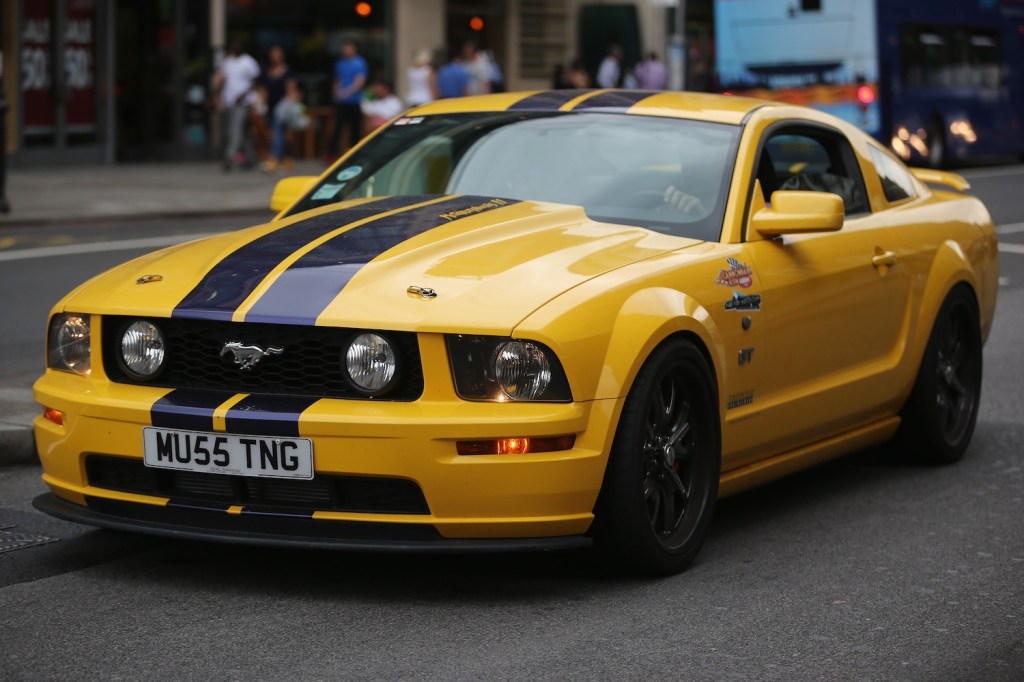 A yellow Ford Mustang on display