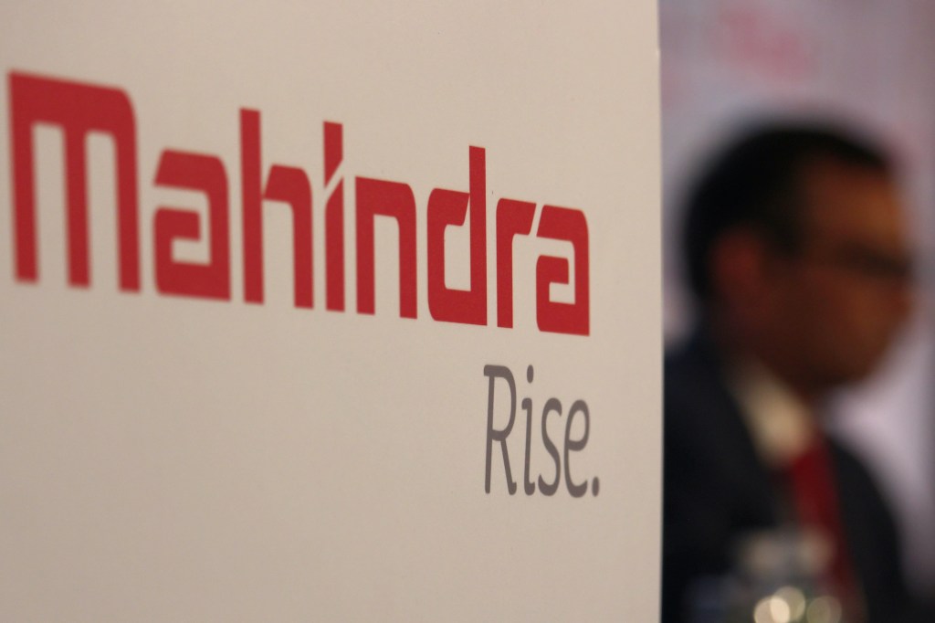 The Mahindra Rise. slogan on a white wall at a convention 