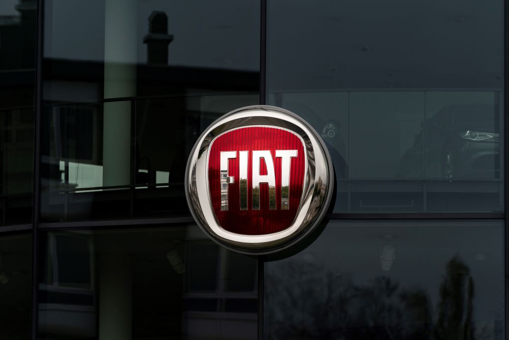 The red and silver Fiat logo on a glass building