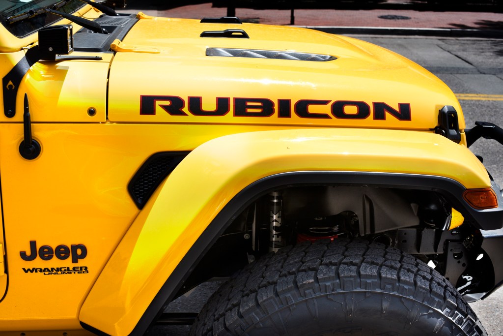A yellow Jeep Wrangler Rubicon parked streetside