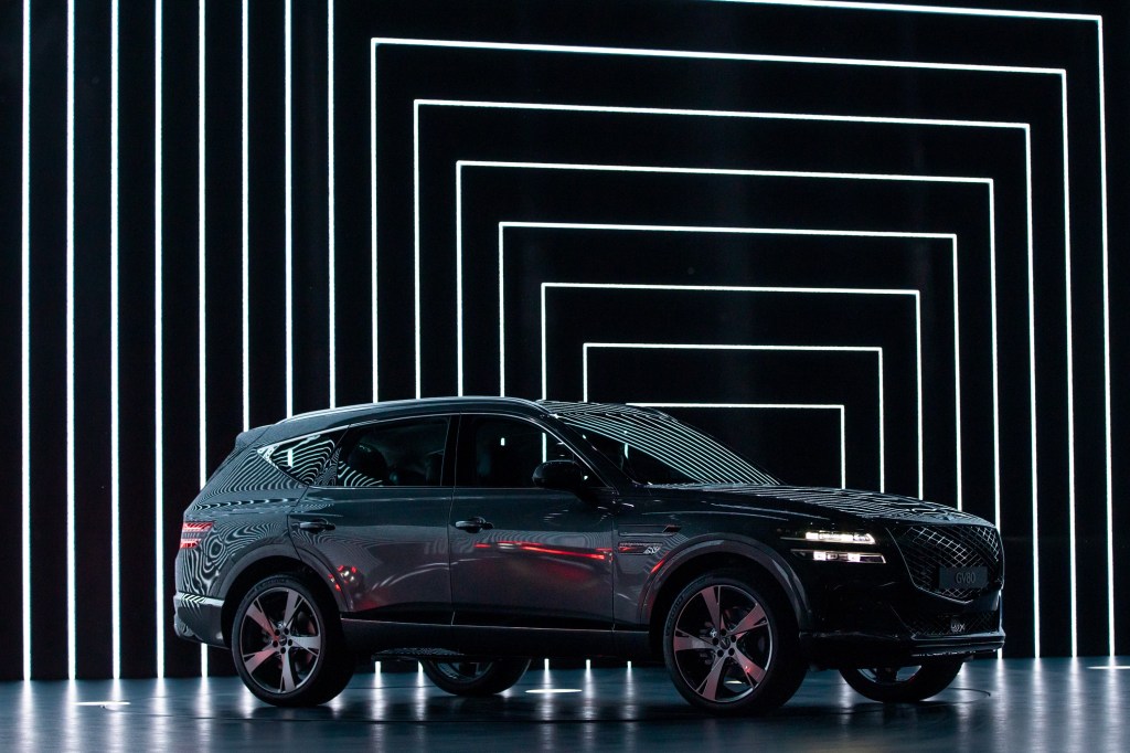 The green Genesis GV80 in front of an infinity mirror