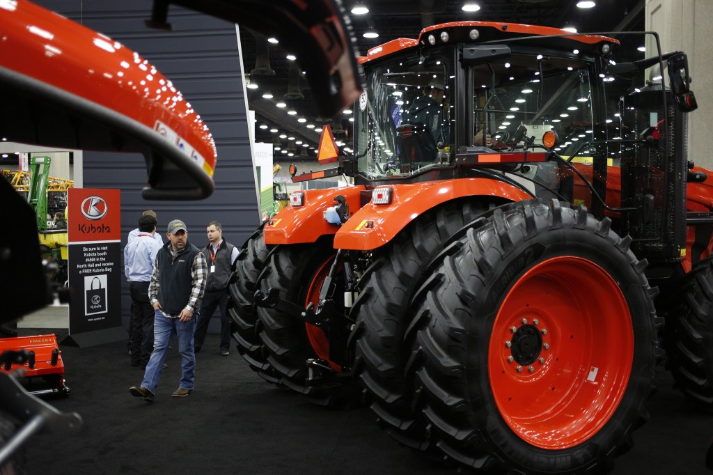 large Kubota tractor models on display at an agriculture expo