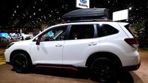 the 2021 Subaru Forester Sport trim on display in white at an auto show