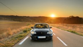 A black Porsche 996-generation 991 as sunset