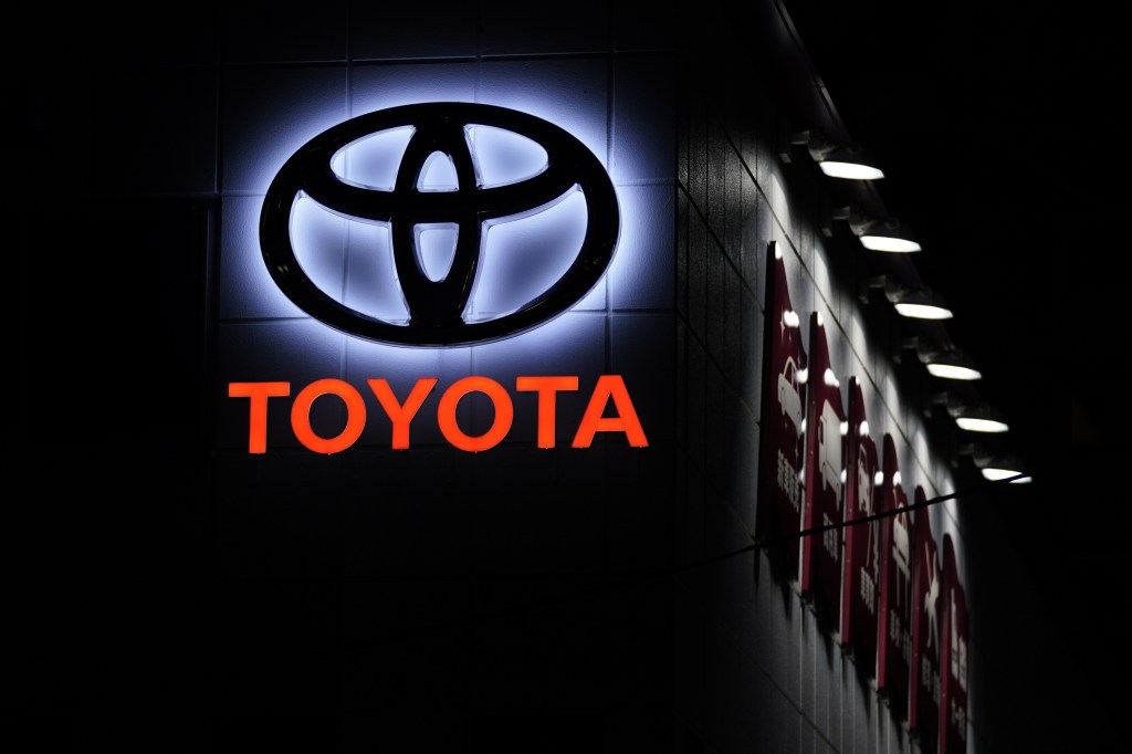 The Toyota logo at night on a building in Japan