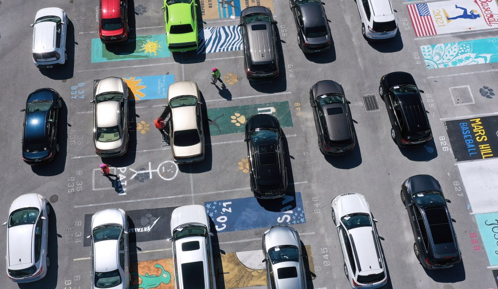 An image of several vehicles parked on their own separate parking spot.