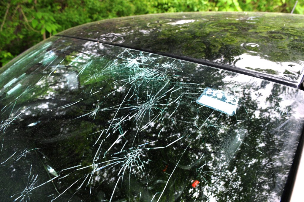 A windshield damaged by hail.