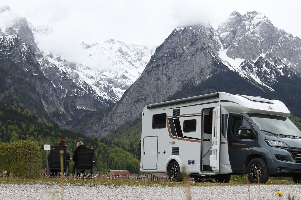 a motorhome camper parked near a stunning mountain view
