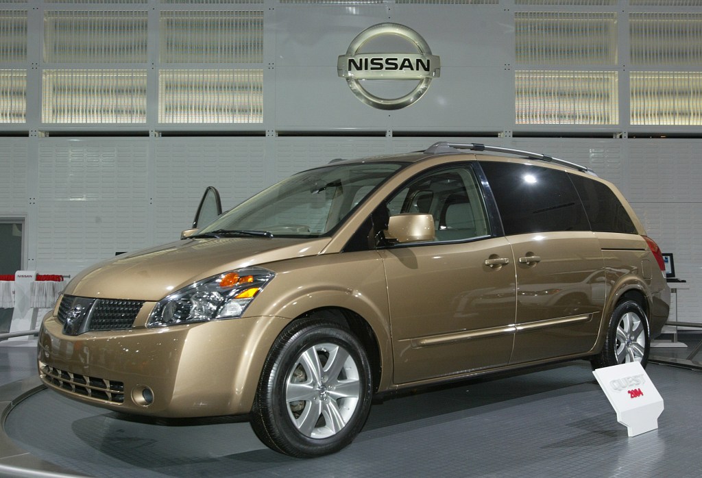 a gold 2003 Nissan Quest on display at an auto show