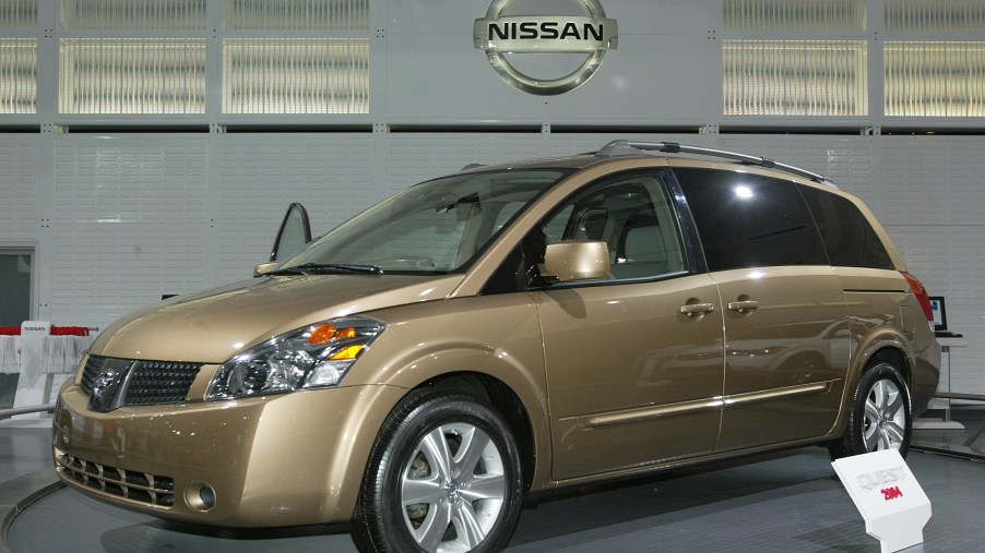 a gold nissan quest minivan at an auto show