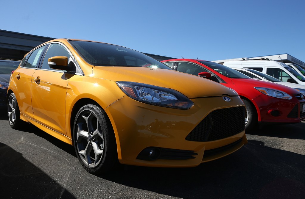 A yellow Ford Focus ST on a dealer lot