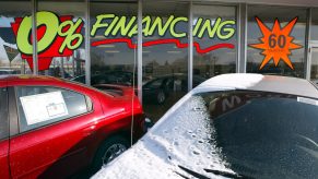 A car dealership advertising car loans in the window