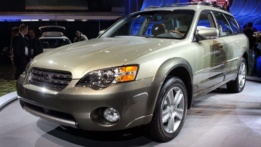 A green Subaru Outback at a press launch