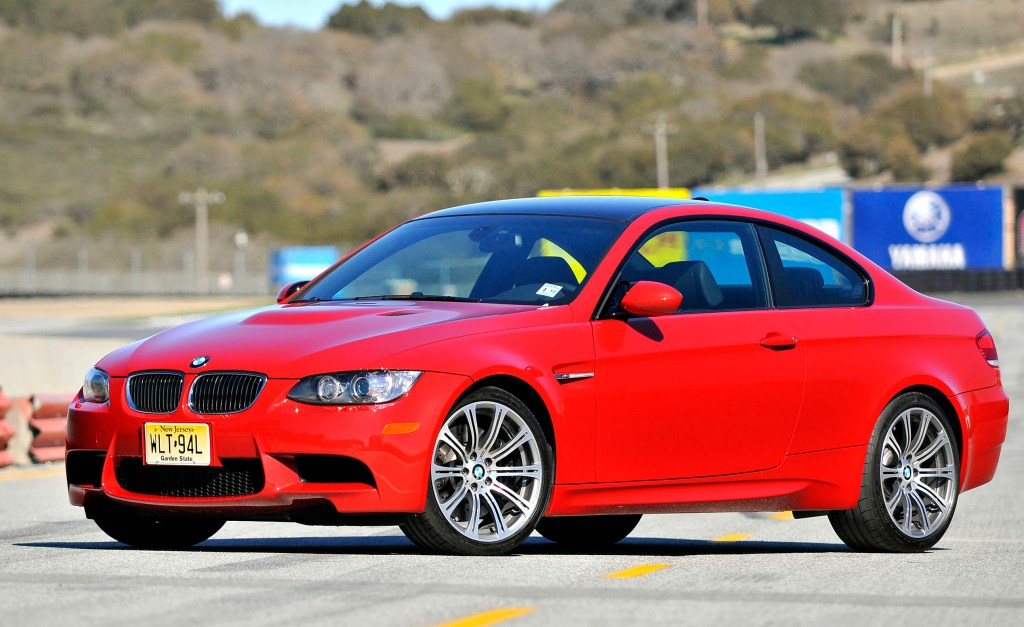 A red 2008 BMW M3 on a racetrack in California